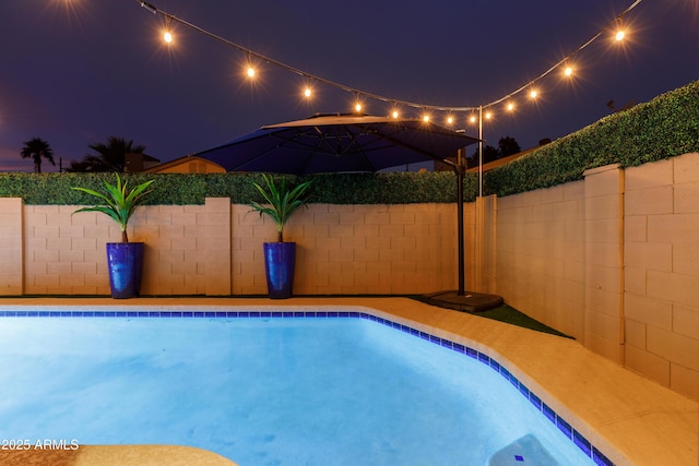 view of pool at night