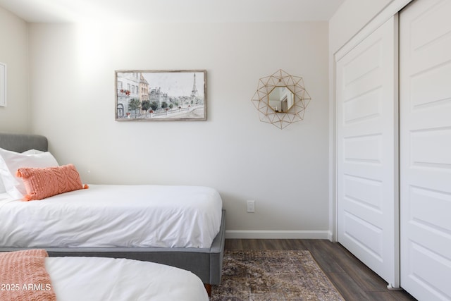 bedroom with a closet and dark hardwood / wood-style flooring