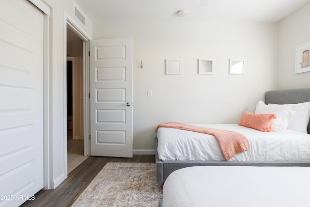 bedroom with dark hardwood / wood-style flooring