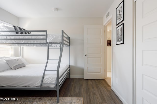 bedroom with dark hardwood / wood-style flooring