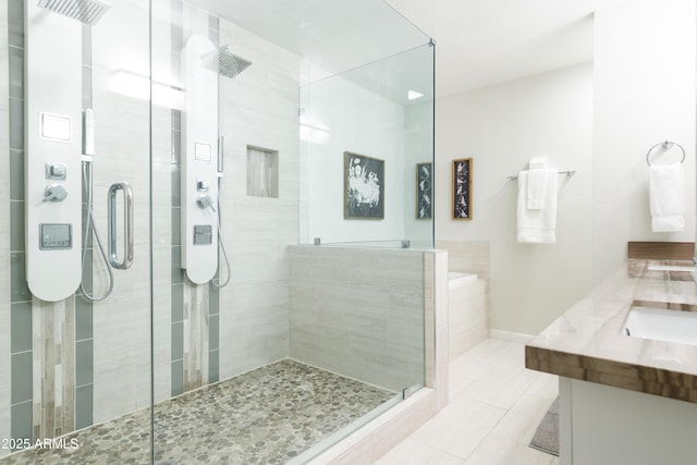 bathroom with vanity, walk in shower, and tile patterned flooring