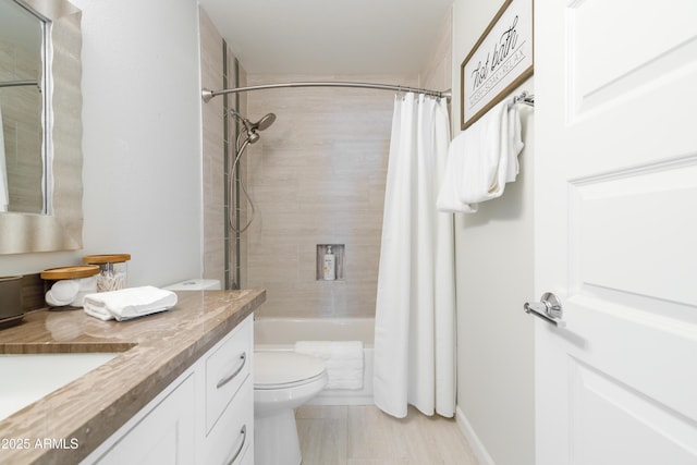 full bathroom featuring toilet, shower / bath combo with shower curtain, and vanity