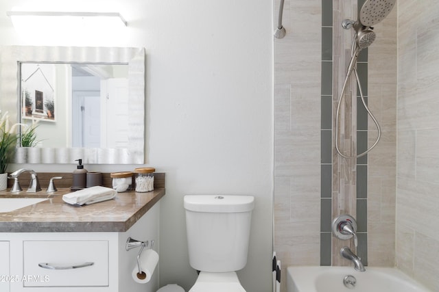 full bathroom featuring vanity, tiled shower / bath combo, and toilet