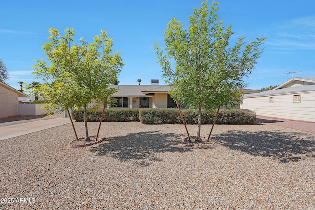 view of front of property featuring an attached garage, driveway, and a chimney