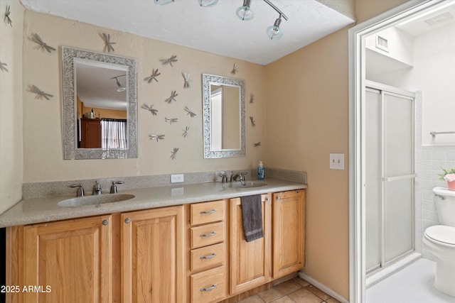 full bath featuring a stall shower, toilet, visible vents, and a sink