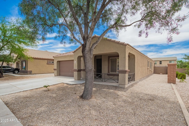 23613 W Mobile Ln, Buckeye, AZ 85326 - mediterranean / spanish-style home featuring stucco siding, an attached garage, a tile roof, and driveway