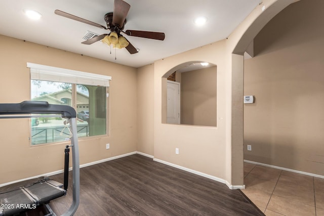 23613 W Mobile Ln, Buckeye, AZ 85326 - exercise room with ceiling fan, arched walkways, baseboards, wood finished floors, and recessed lighting