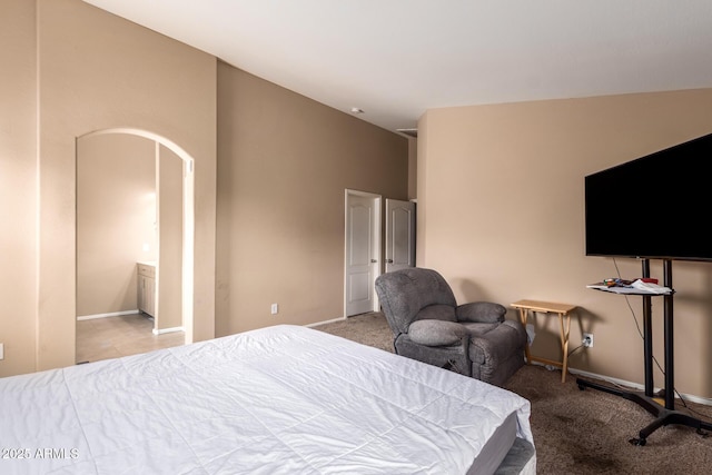 23613 W Mobile Ln, Buckeye, AZ 85326 - bedroom featuring arched walkways, baseboards, carpet flooring, and lofted ceiling