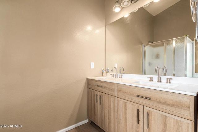 23613 W Mobile Ln, Buckeye, AZ 85326 - bathroom with double vanity, a stall shower, tile patterned flooring, and baseboards
