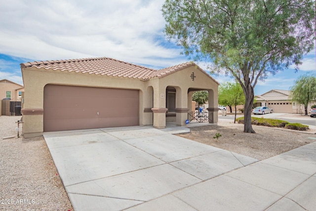 23613 W Mobile Ln, Buckeye, AZ 85326 - mediterranean / spanish house featuring stucco siding, an attached garage, driveway, and a tiled roof