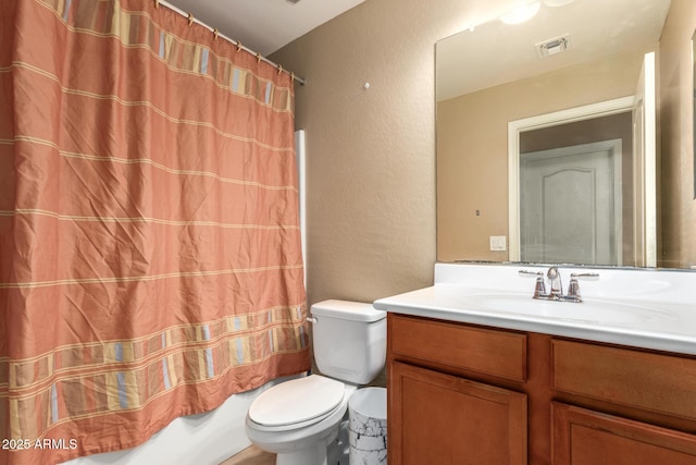 23613 W Mobile Ln, Buckeye, AZ 85326 - full bathroom featuring toilet, a textured wall, vanity, and shower / tub combo