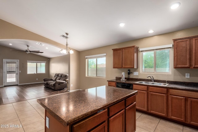 23613 W Mobile Ln, Buckeye, AZ 85326 - kitchen with a sink, vaulted ceiling, dark countertops, dishwasher, and light tile patterned floors