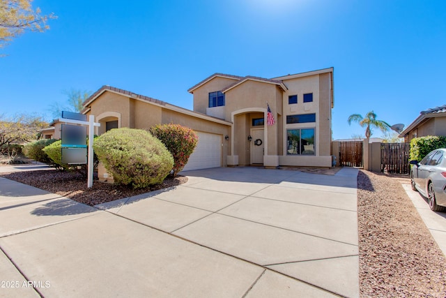 view of front facade with fence, stucco siding, concrete driveway, a garage, and a tile roof