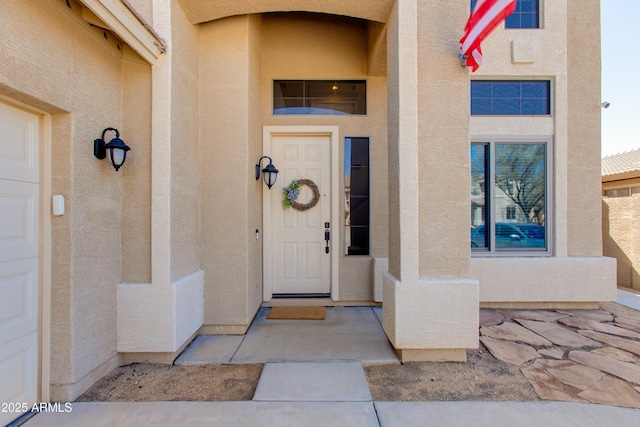 doorway to property featuring stucco siding