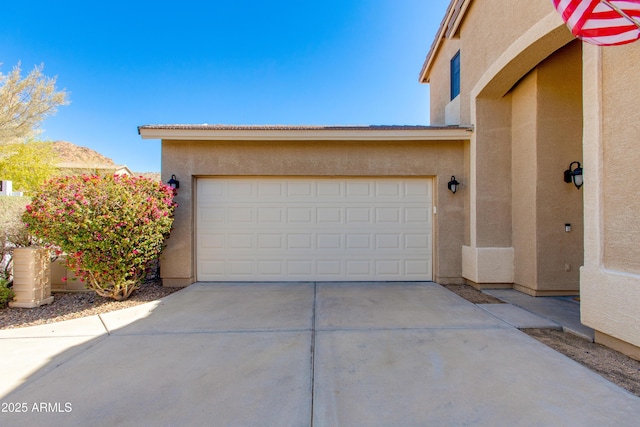 garage with concrete driveway