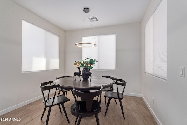 dining area with light hardwood / wood-style floors and a wealth of natural light