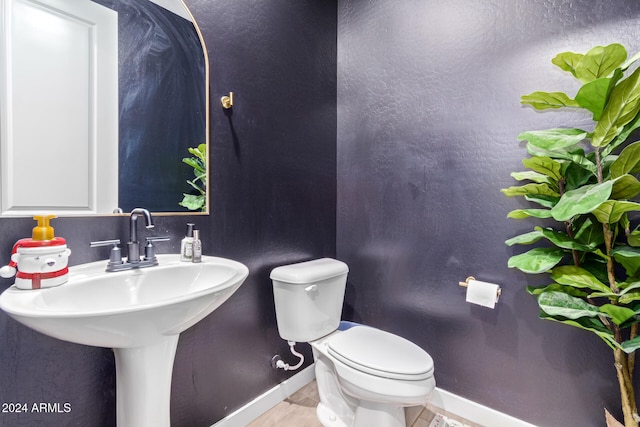 bathroom with sink, tile patterned flooring, and toilet