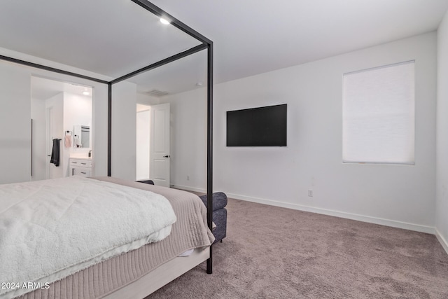 carpeted bedroom featuring connected bathroom