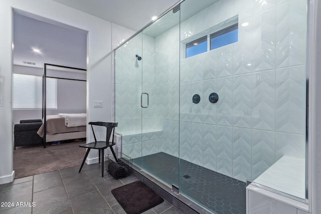 bathroom featuring tile patterned flooring and an enclosed shower