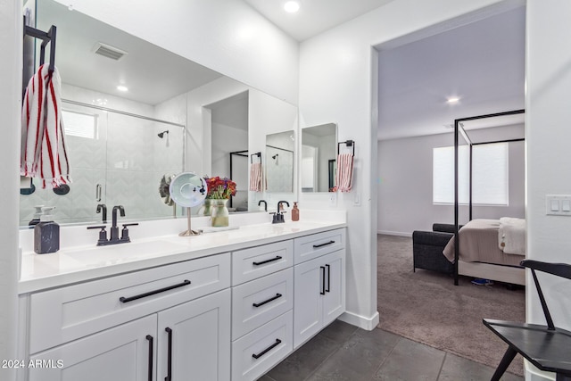 bathroom with a shower with door, vanity, a healthy amount of sunlight, and tile patterned flooring