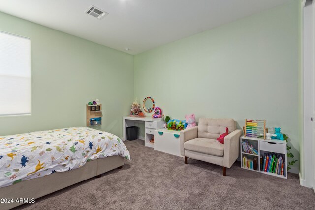 carpeted bedroom featuring multiple windows