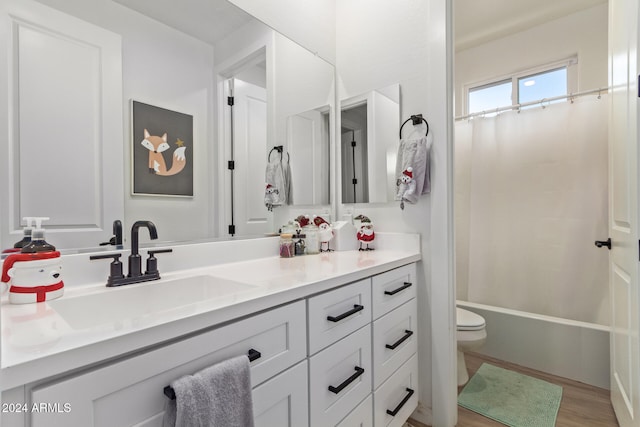 full bathroom featuring vanity, toilet, wood-type flooring, and shower / bath combo with shower curtain