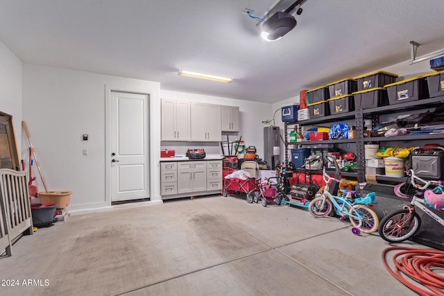 garage with a garage door opener and water heater