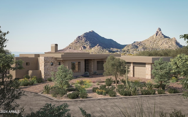 view of front facade featuring a mountain view and a garage