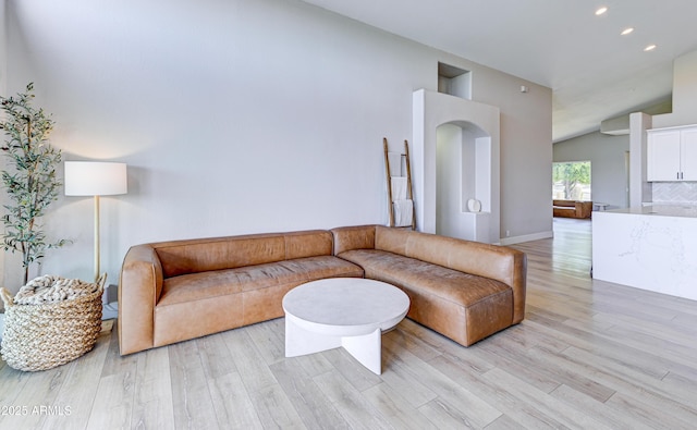 living area with lofted ceiling, light wood finished floors, and recessed lighting