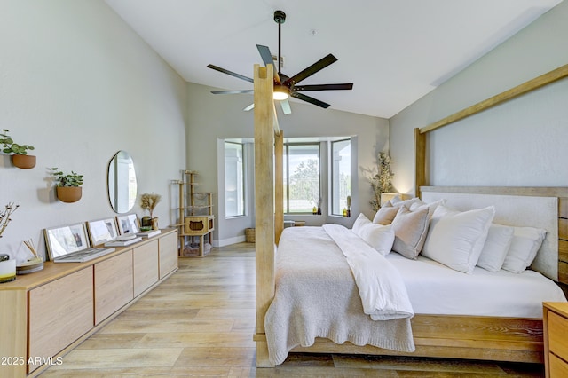 bedroom featuring light wood-style floors, lofted ceiling, and ceiling fan