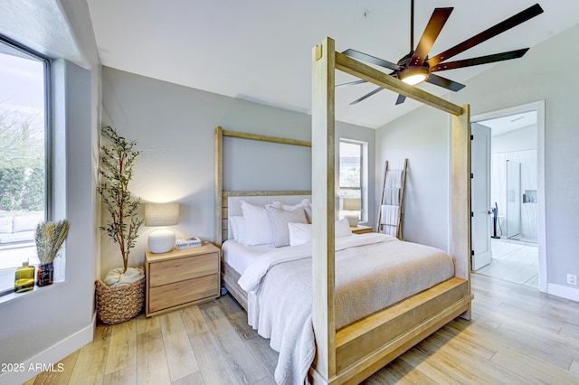 bedroom featuring a ceiling fan, light wood-style flooring, and baseboards