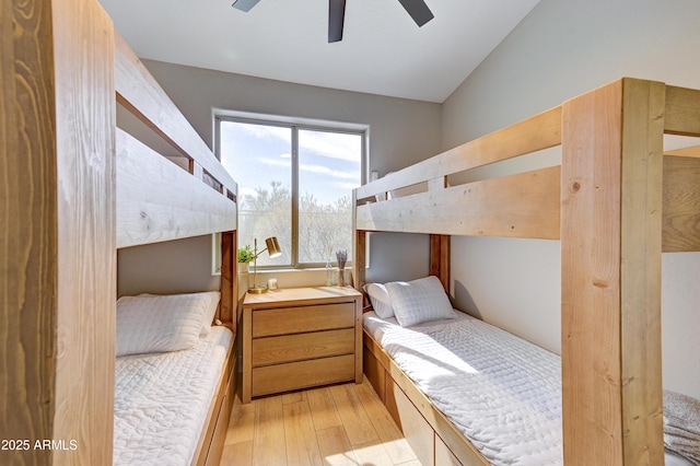 bedroom with vaulted ceiling, light wood-style flooring, and ceiling fan