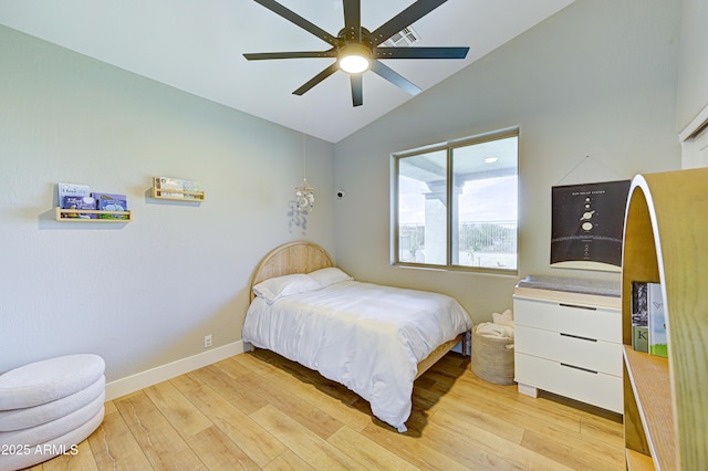 bedroom with light wood-type flooring, ceiling fan, baseboards, and vaulted ceiling