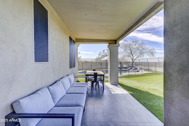 view of patio featuring a swimming pool and fence