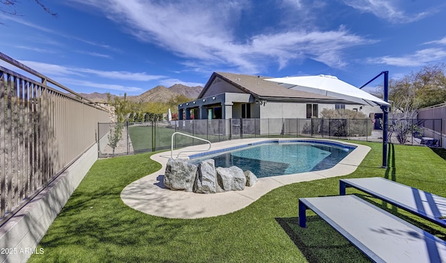 view of swimming pool featuring a lawn, a fenced backyard, a mountain view, and a fenced in pool