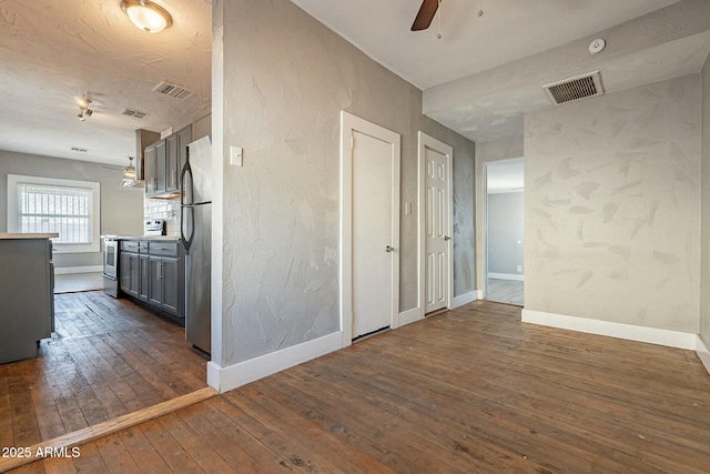 interior space featuring ceiling fan and dark hardwood / wood-style flooring