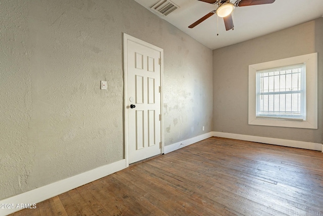 spare room with ceiling fan and wood-type flooring