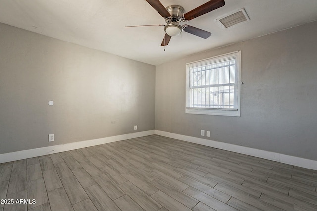 spare room featuring ceiling fan and light hardwood / wood-style flooring