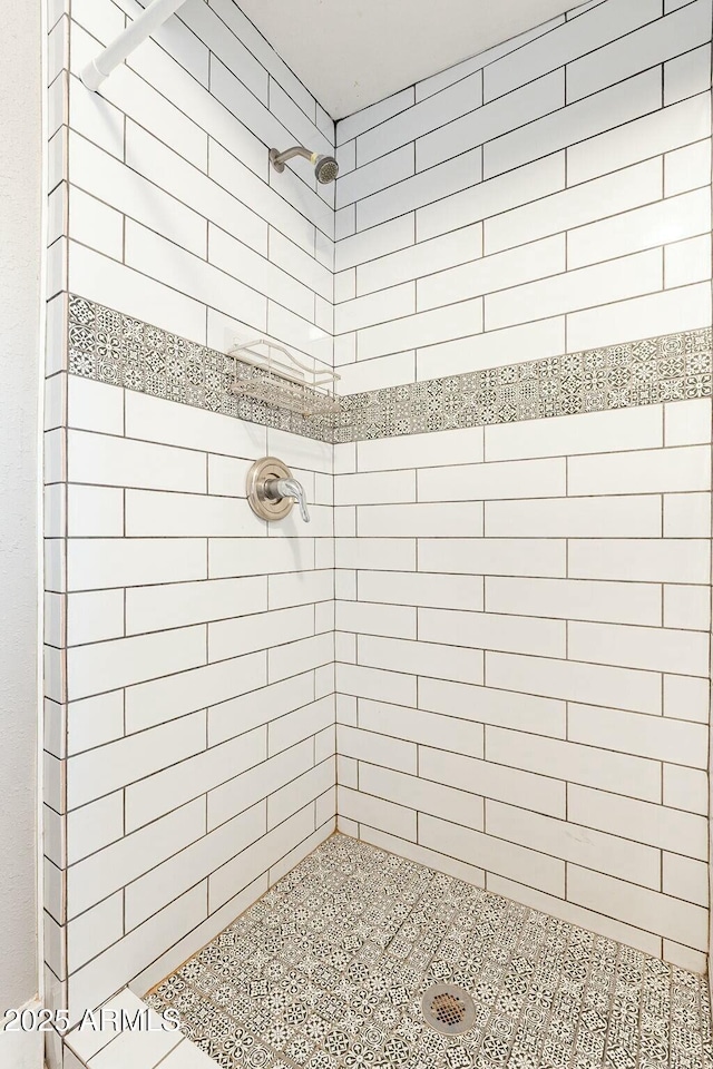 bathroom with tiled shower