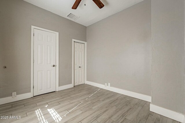 unfurnished bedroom with ceiling fan and light hardwood / wood-style flooring