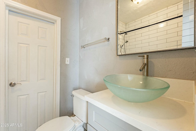 bathroom with toilet and vanity