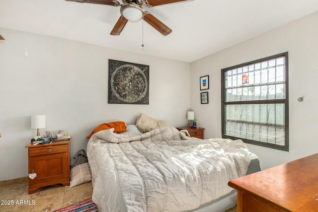 bedroom with ceiling fan and light tile patterned flooring