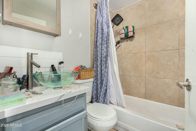 full bathroom with toilet, vanity, and shower / tub combo