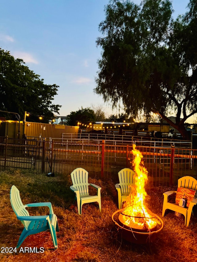 patio terrace at dusk featuring a fire pit