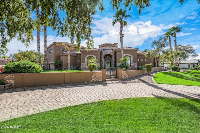 mediterranean / spanish home with a front yard