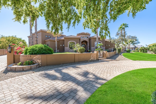 mediterranean / spanish-style house featuring a front lawn