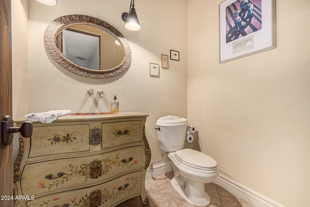 bathroom featuring tile patterned floors, vanity, and toilet