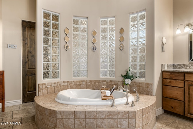 bathroom with vanity and a relaxing tiled tub