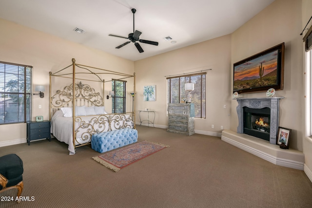 unfurnished bedroom with dark colored carpet and ceiling fan