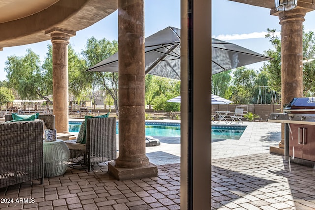 view of patio with a fenced in pool